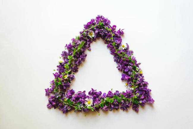 Triangle of flowers that are purple and green