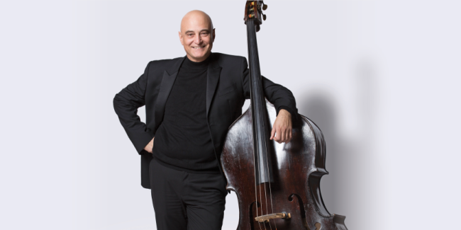 Milton Masciadri, professor of double bass, in front of a white background