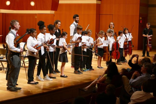 UGA String Project students display their completion certificates alongside their instructors, Hodgson School music education students, at the conclusion of their spring performance in Hodgson Concert Hall last April.