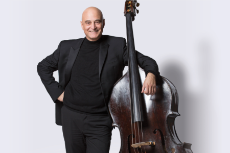 Milton Masciadri, professor of double bass, in front of a white background