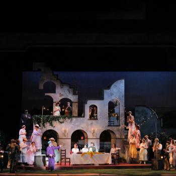 Dulcamara (2019 UGA guest artist Stefano de Peppo, “Don Pasquale”) addresses the crowd in Minnesota Opera’s production of “Elixir of Love” directed by Daniel Ellis in January, 2024. (Photo by Cory Weaver)